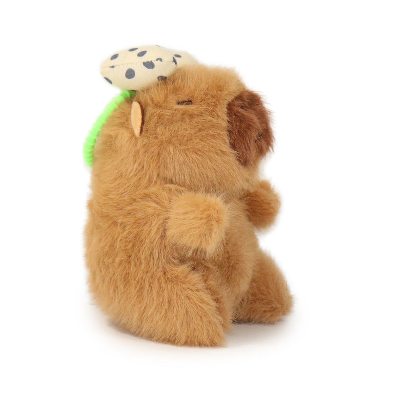 Plush toy resembling a hedgehog with a green tail on a white background