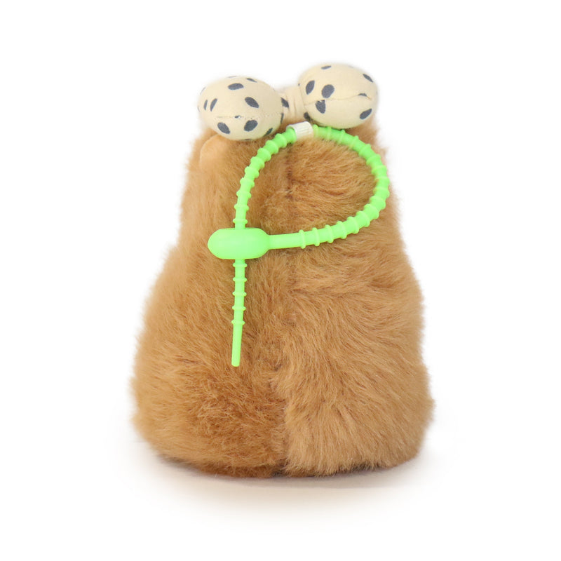 Plush toy with a green string and polka dot balls on a white background