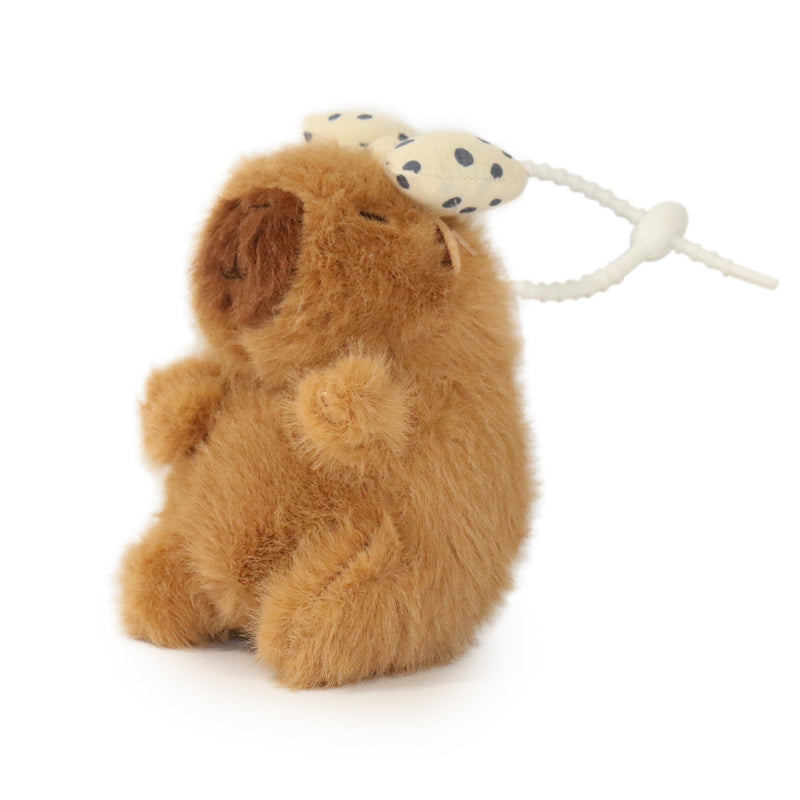 Plush toy lion with a rattle on a white background