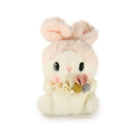 Plush toy rabbit with a heart and bow on a white background