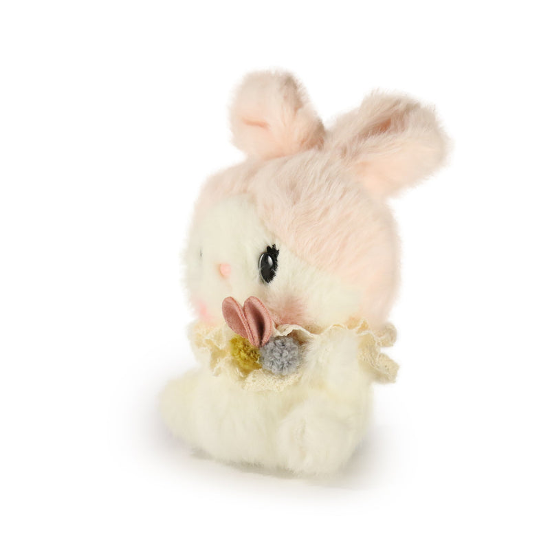 Small plush rabbit toy with a bow on a white background