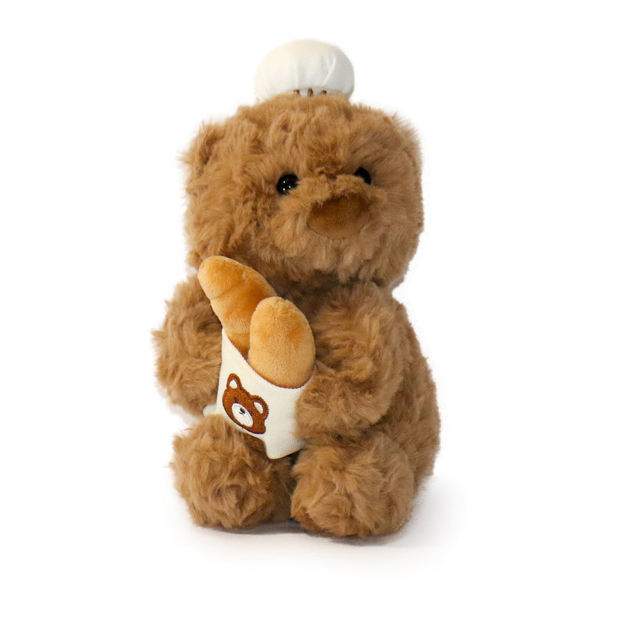 Brown teddy bear holding a small bag with a bear design on a white background