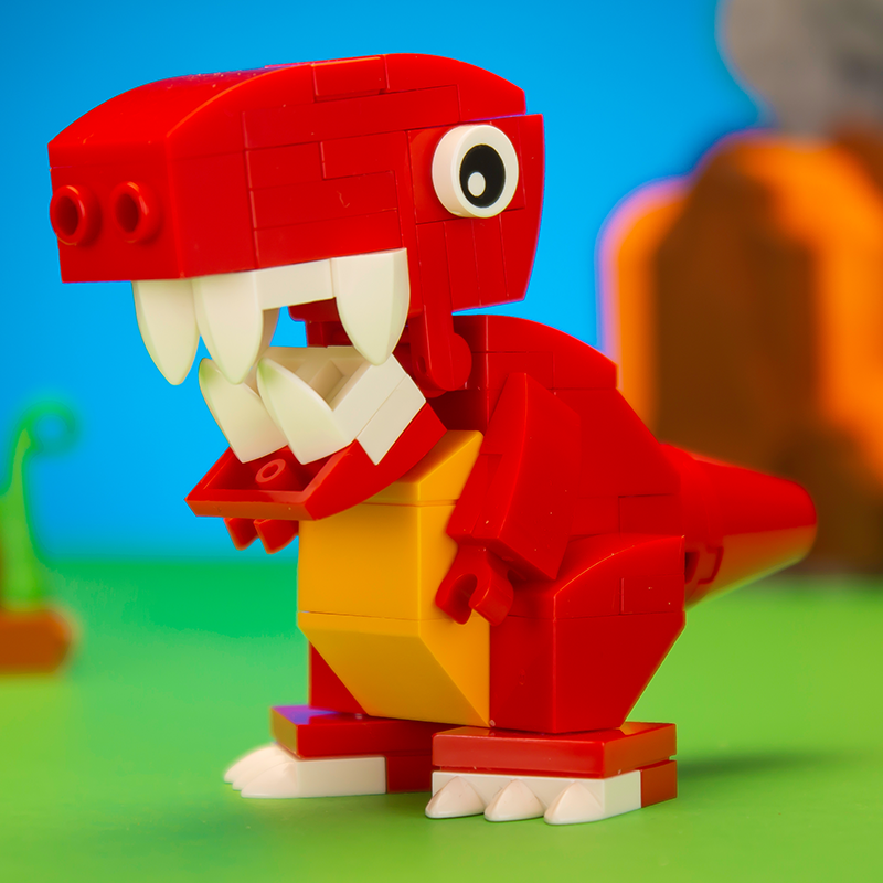 Red and yellow toy dinosaur made of interlocking bricks on a green and blue background