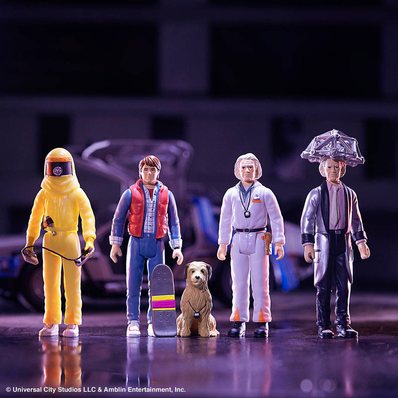 Five action figures in various outfits with a blurred background