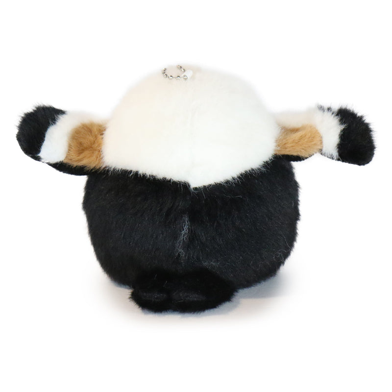 Plush toy panda with a white face and black body on a white background