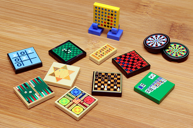 Collection of various board games on a wooden surface