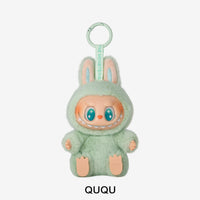 Plush toy character in a green outfit with 'QUQU' branding on a white background