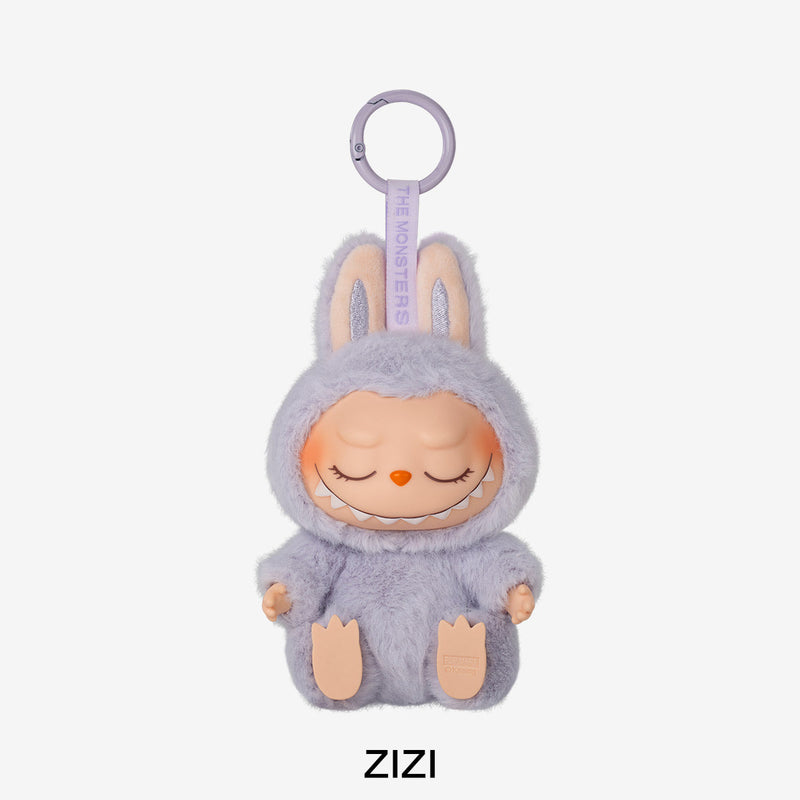 Plush toy with a purple hood and pink face on a white background, featuring the brand 'ZIZI'.