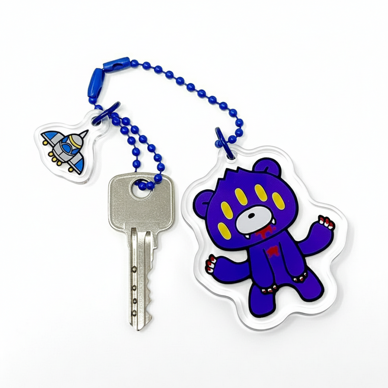 Keychain with a blue cartoon bear character on a white background