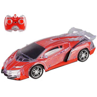 Red toy car with clear side panels and a remote control on a white background