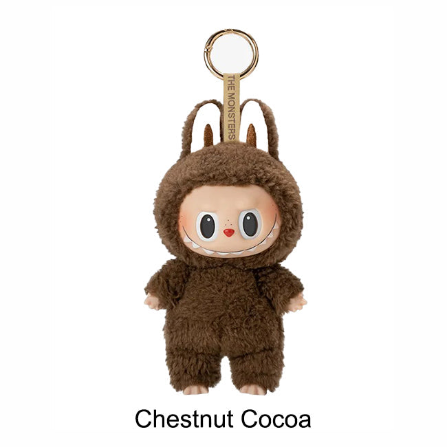 Plush keychain in chestnut cocoa color with 'The Monsters' branding on a white background.