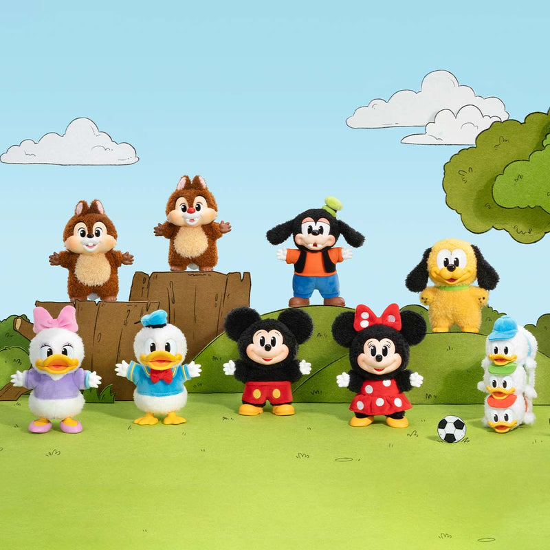 Cartoon character figurines on a grassy field with a blue sky background