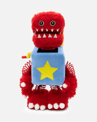 Red plush toy with a blue square and yellow star on a white background