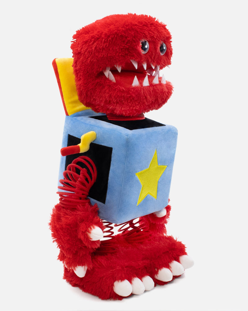 Red plush toy with a box and star design on a white background