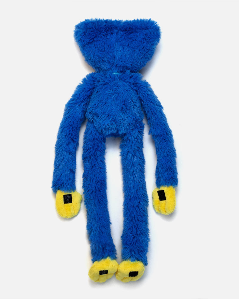 Blue plush toy with yellow paws on a white background