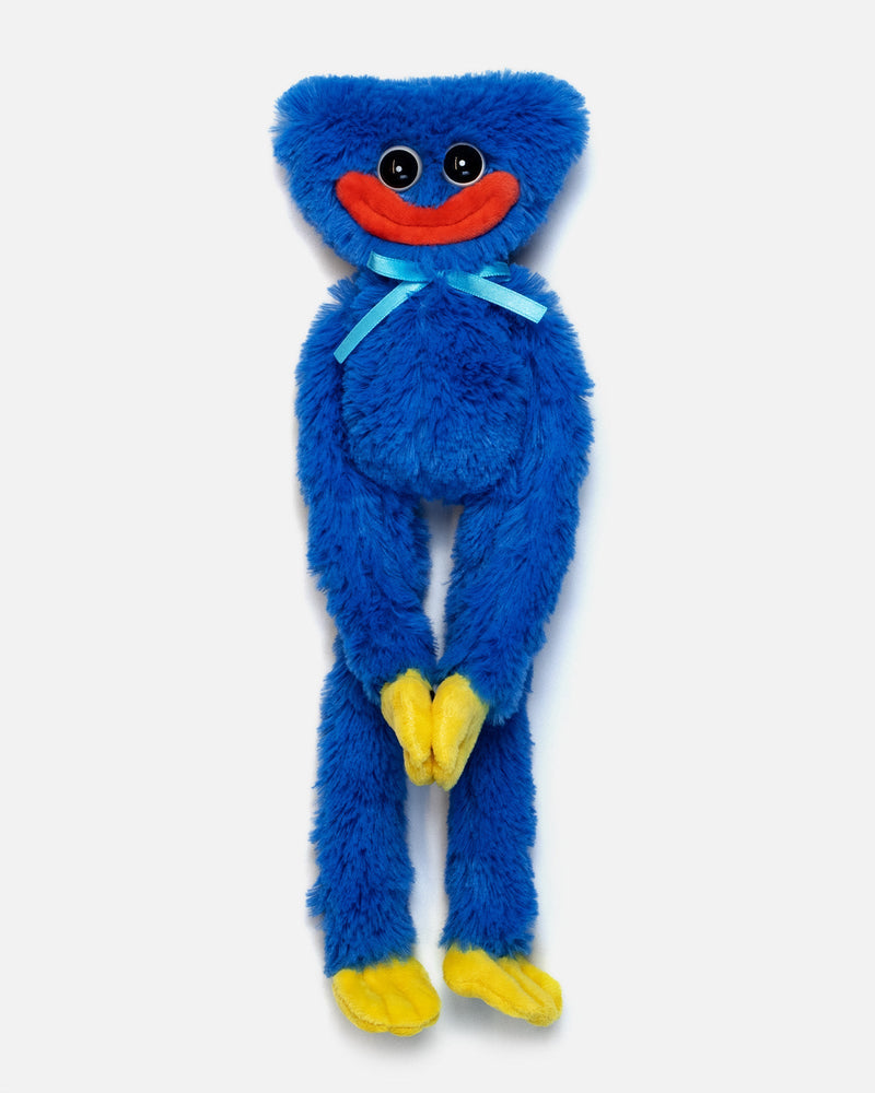 Blue plush toy with a red mouth and yellow feet on a white background