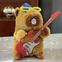 A cute capybara plush toy holding a red electric guitar, wearing yellow glasses and a blue hat, displayed on a tabletop.