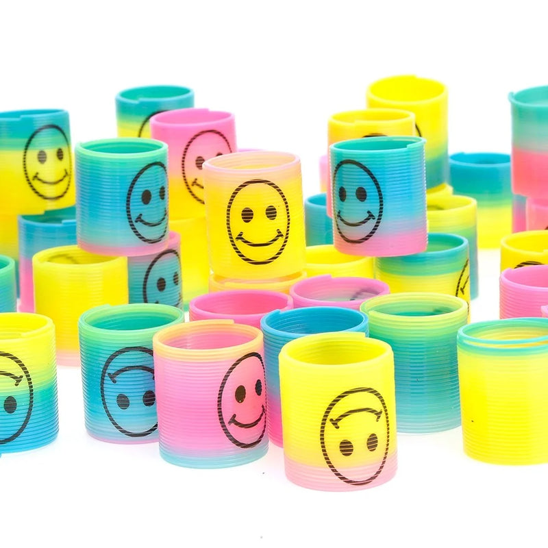 Assorted Mini Rainbow Emoticon Springs - vibrant toy coil springs with smiley faces in pink, yellow, and blue colors