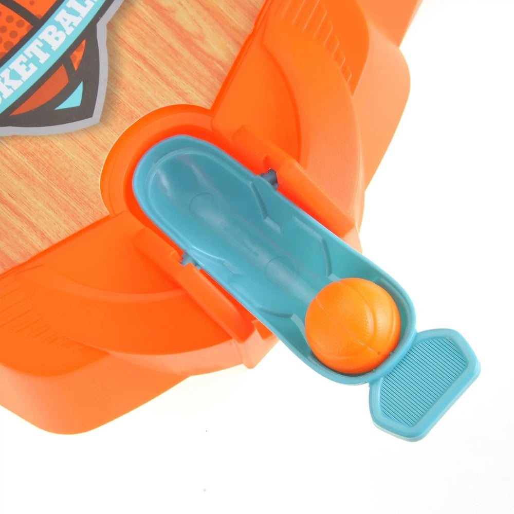 Basketball tabletop game with ball placed in the launcher for shooting.