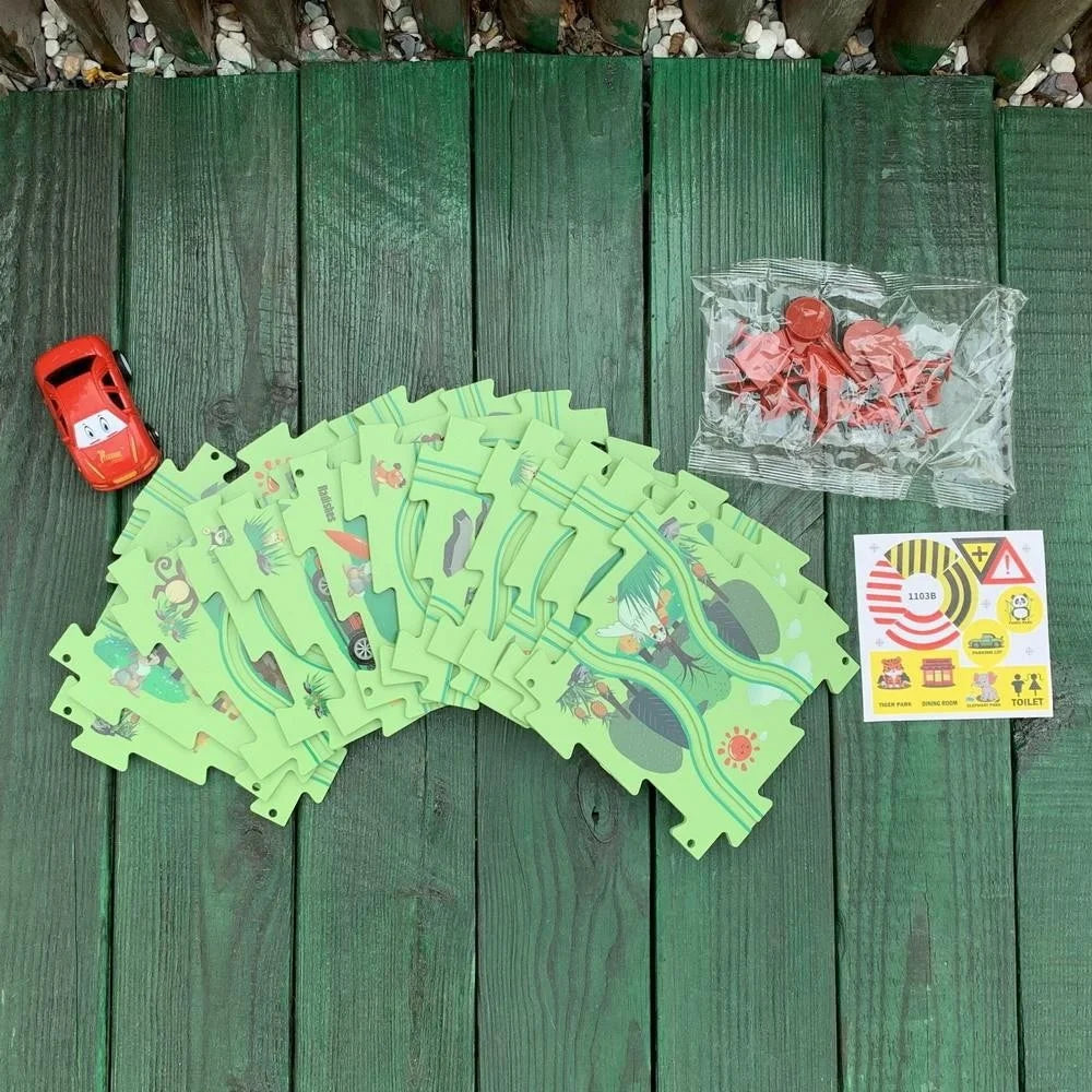 Car track puzzle set with green puzzle pieces, road signs, stickers, and a red car, ideal for young children's learning and play.