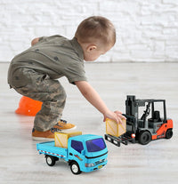 A child playing with a toy forklift and truck set, featuring realistic lifting action.