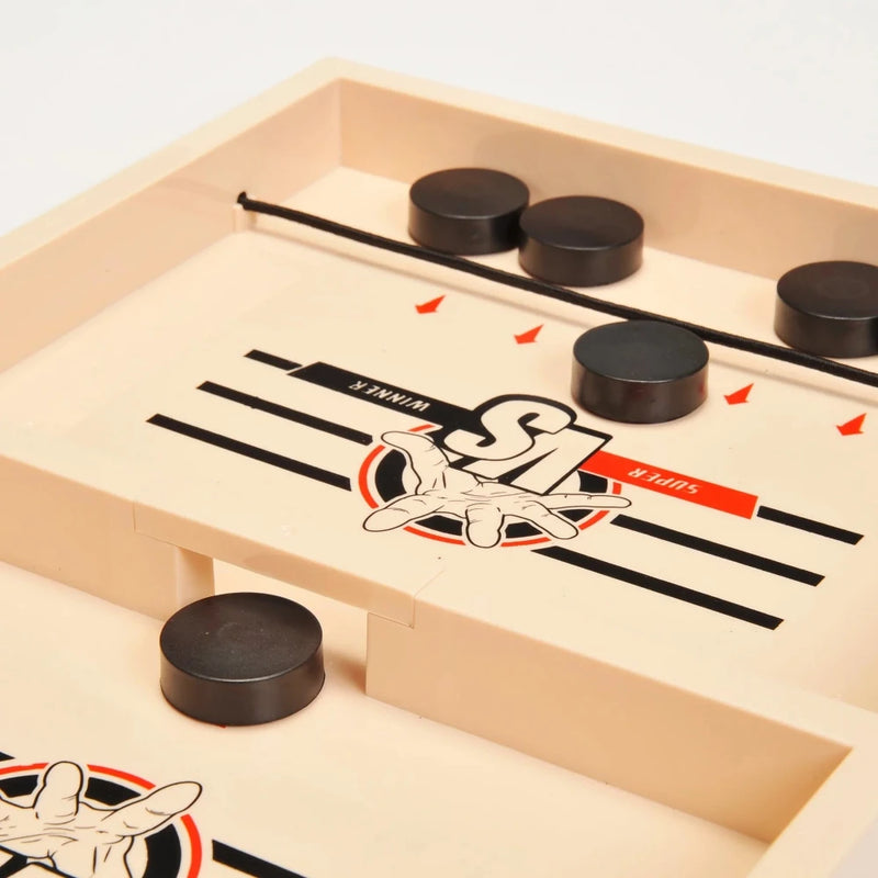 Close-up view of the Battle Catapult game board showing puck positions and elastic sling for fast-paced gameplay