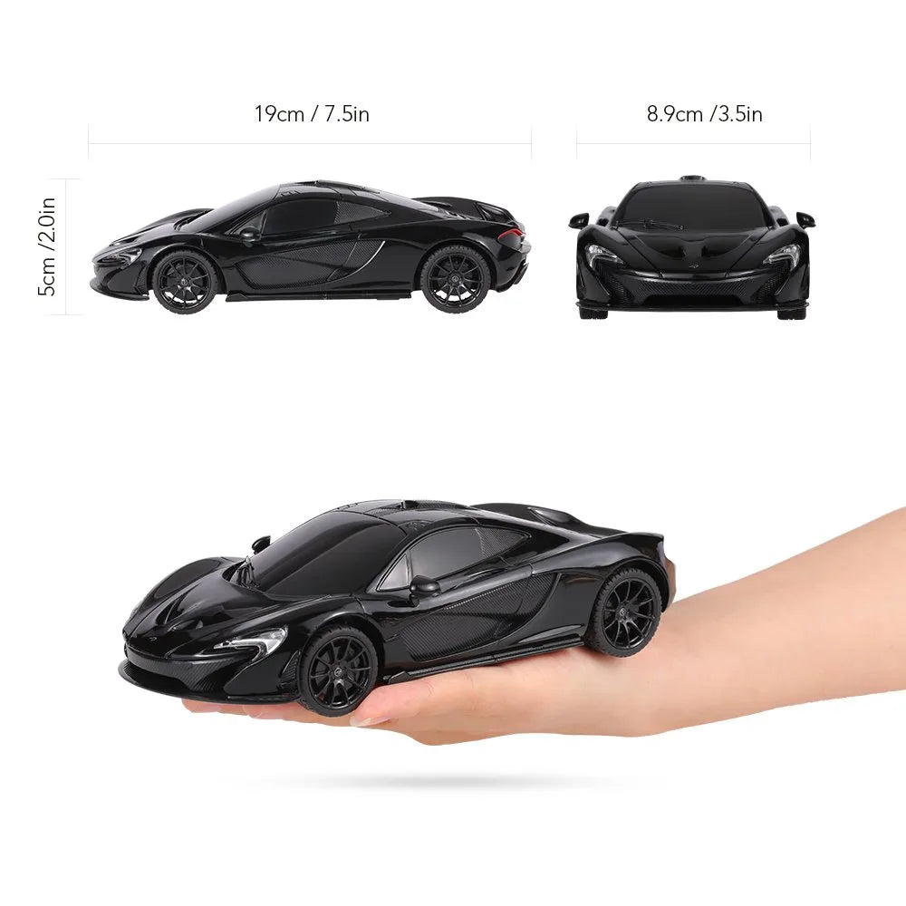 Black toy car held in a hand with measurements displayed