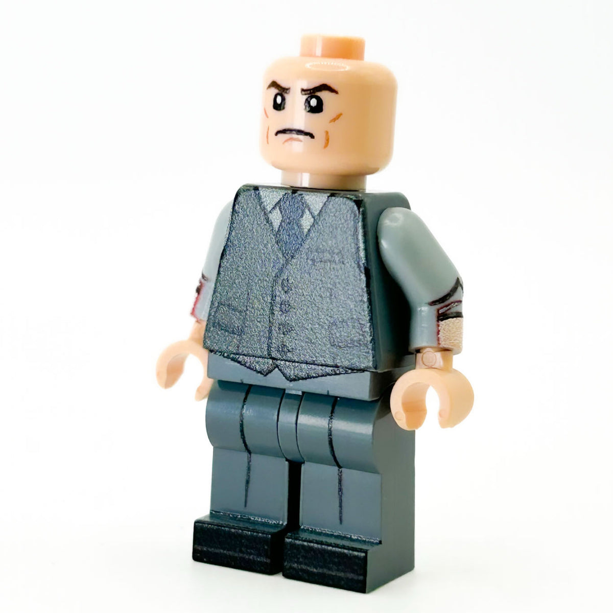 Toy figure of a person wearing a suit on a white background