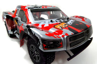 Model truck with red and black camouflage design on a white background