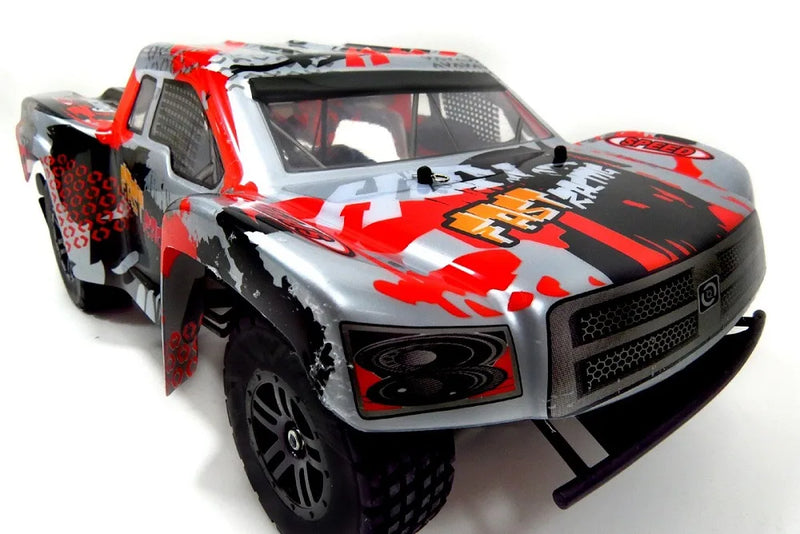 Model truck with red and black camouflage design on a white background