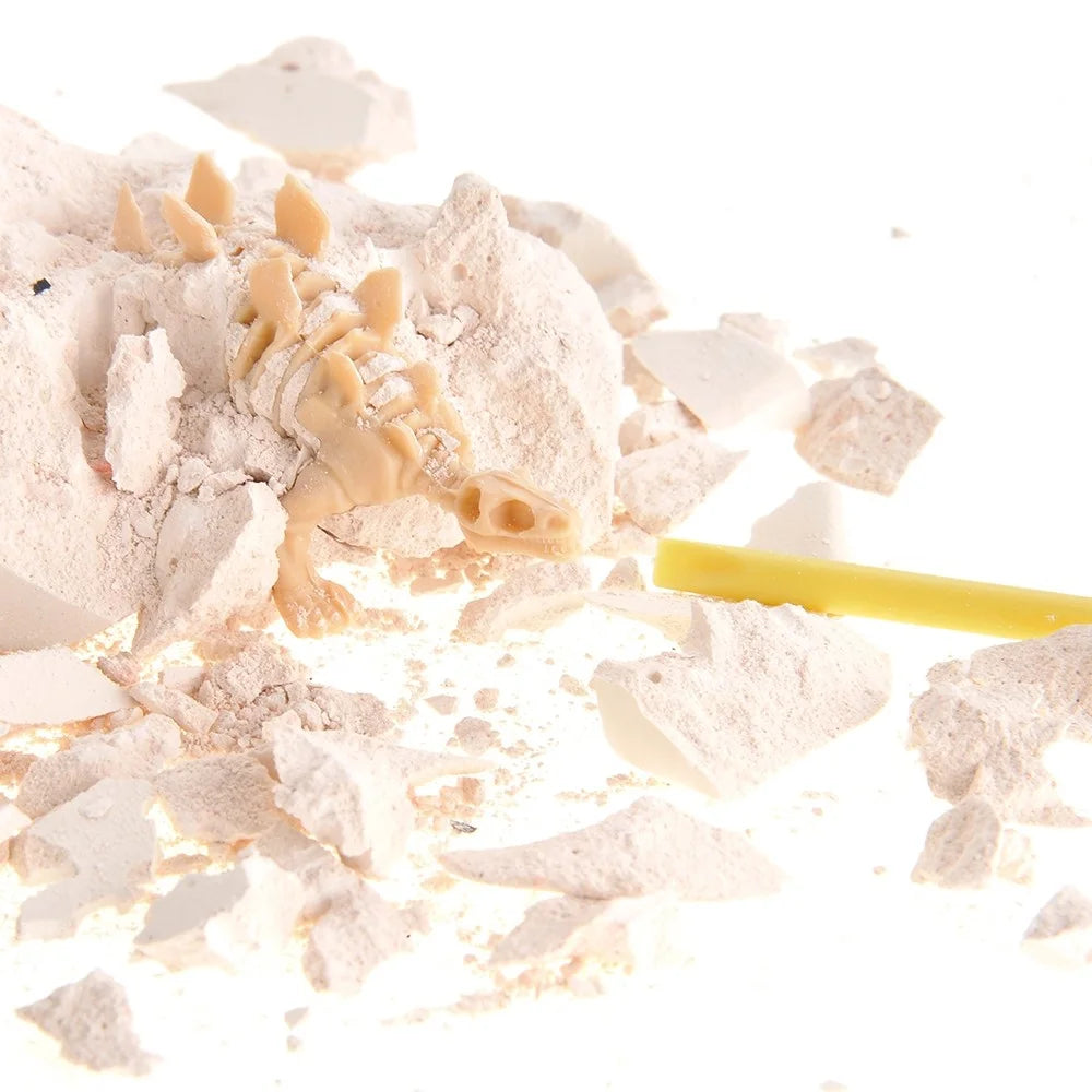 Close-up of the dinosaur skeleton excavation process with tools and crushed block material.