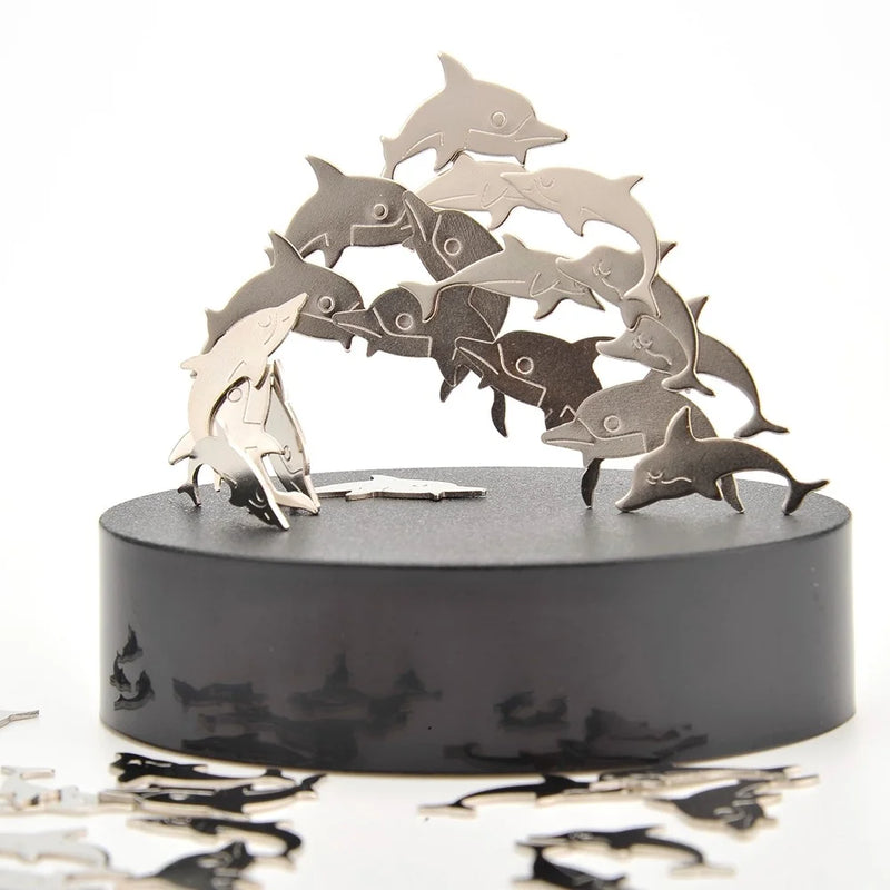 Dolphin-shaped magnetic pieces forming a sculpture on a sleek black platform, ideal for stress relief.