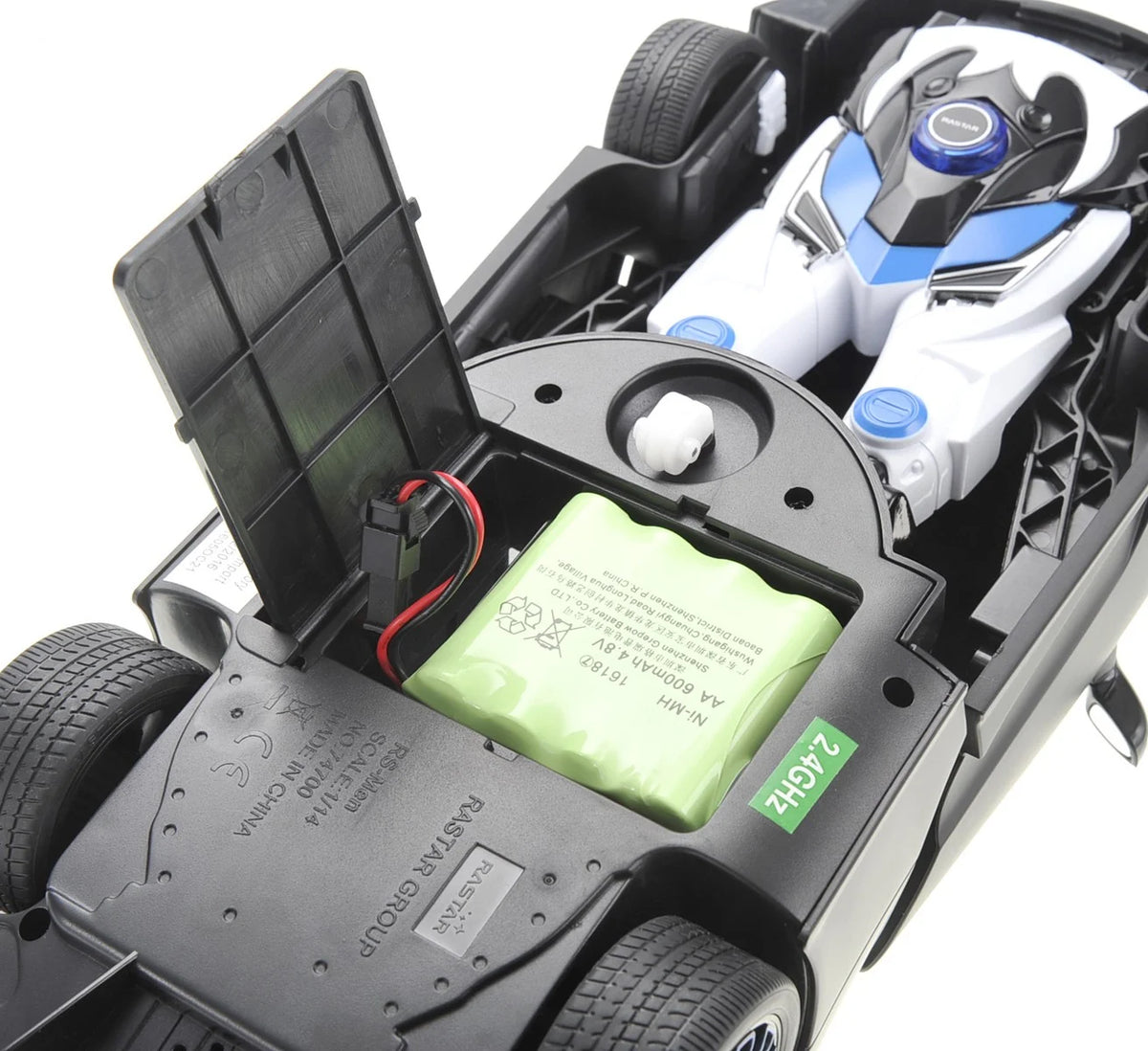 Close-up of a toy car with an open compartment revealing a battery and mechanical components.