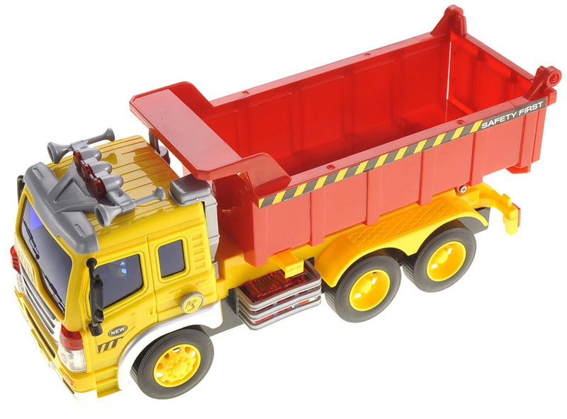 Top view of extra-large toy dump truck with a spacious red container, ideal for kids' creative play.