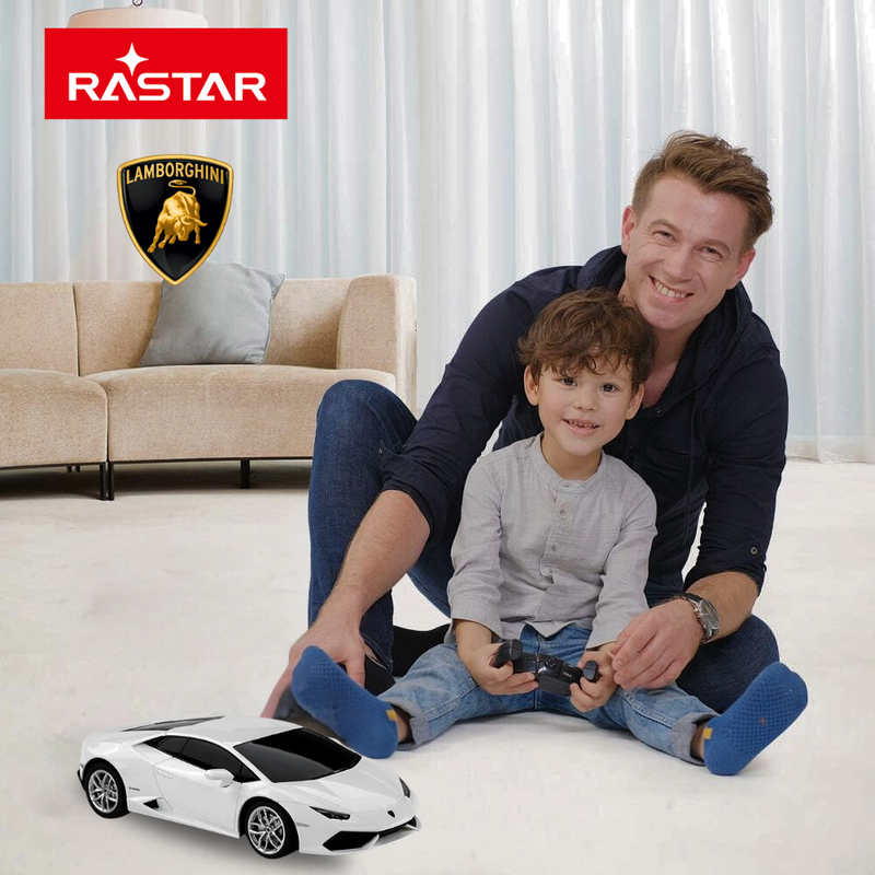 Father and son enjoying playtime with RC Lamborghini Huracan car by Rastar.

