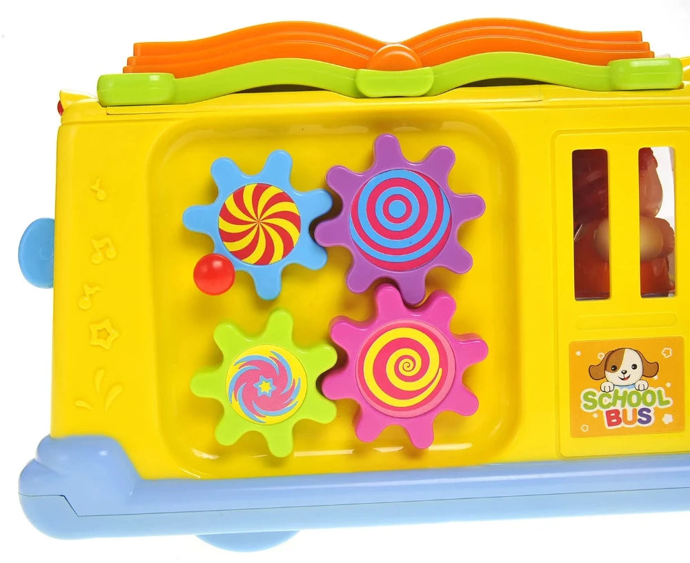 Close-up of colorful gears on the side of a school bus toy, perfect for developing motor skills in toddlers.