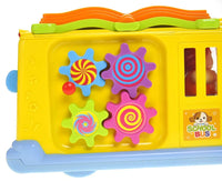 Close-up of colorful gears on the side of a school bus toy, perfect for developing motor skills in toddlers.