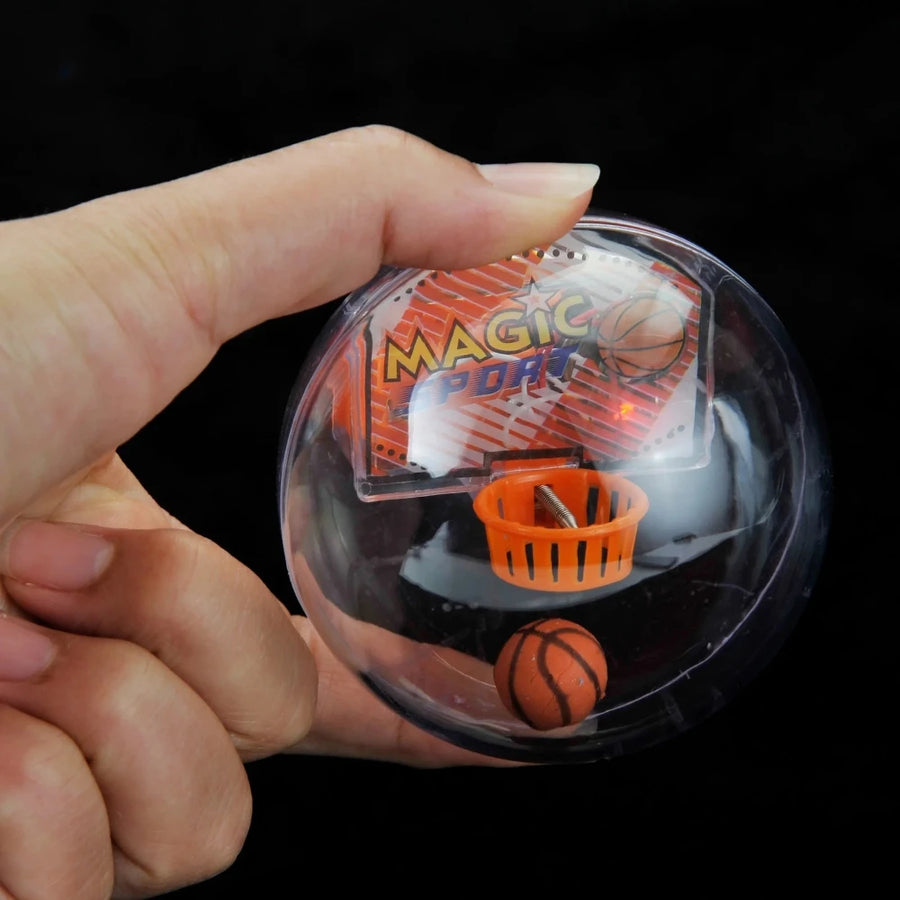 Hand holding Magic Sports Basketball Game Ball for kids - fun handheld toy with mini hoop and basketball.