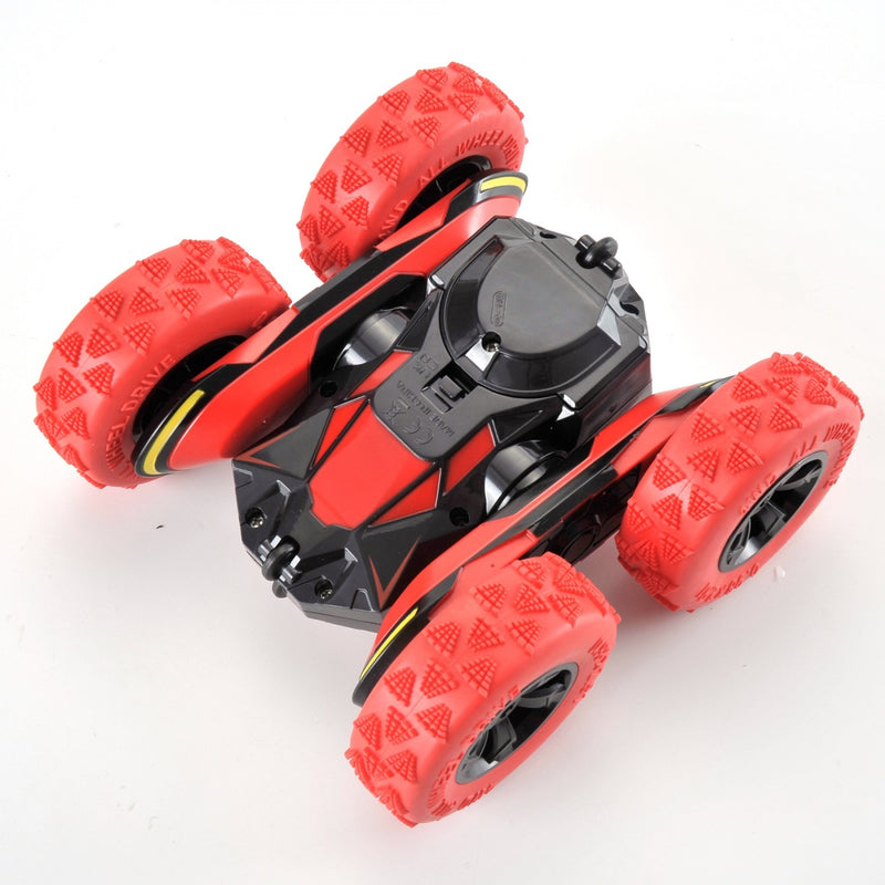 Red and black toy vehicle with large wheels on a white background