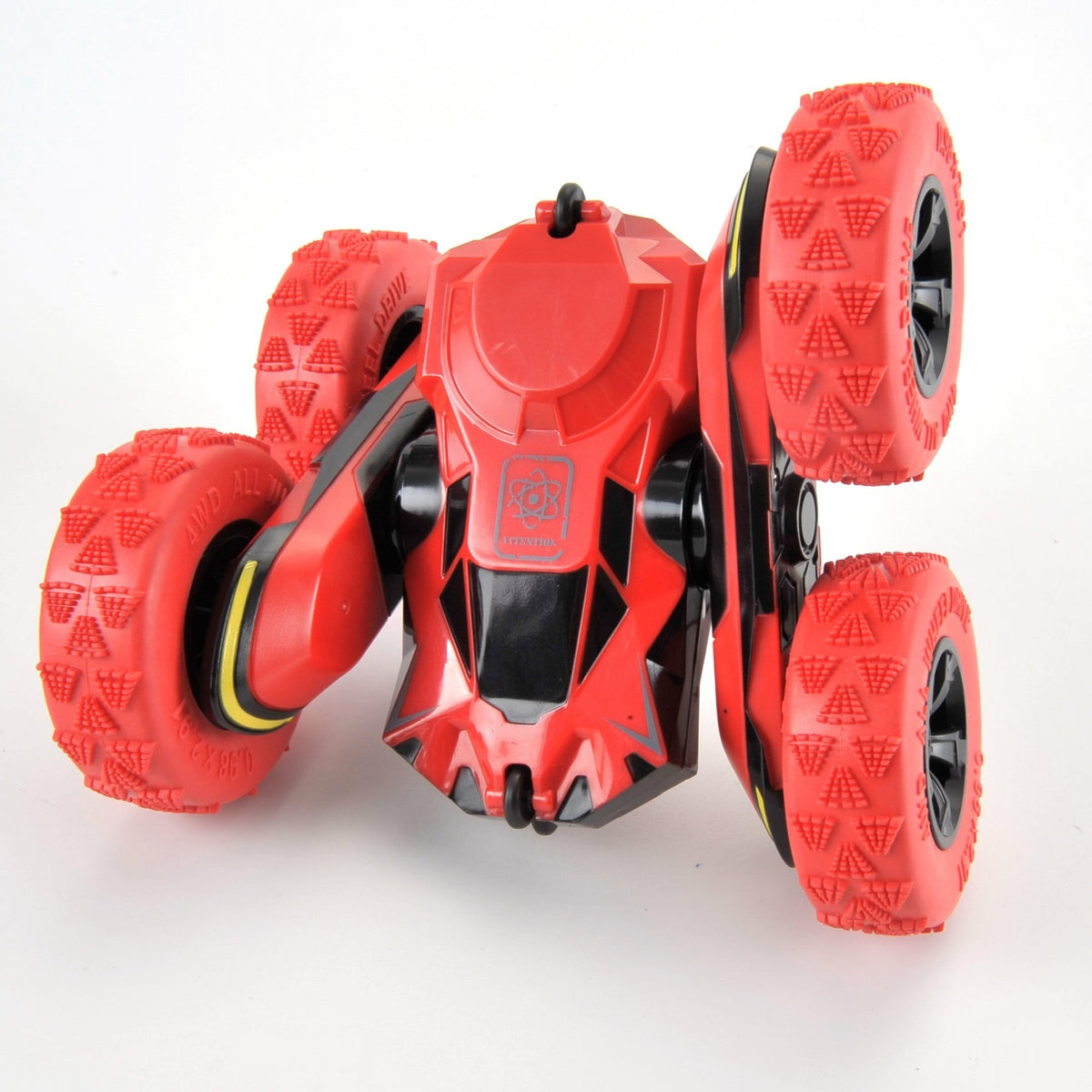 Red toy vehicle with large wheels on a white background
