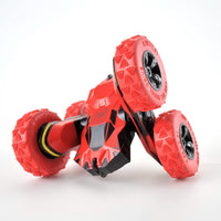 Red toy car with large wheels on a white background