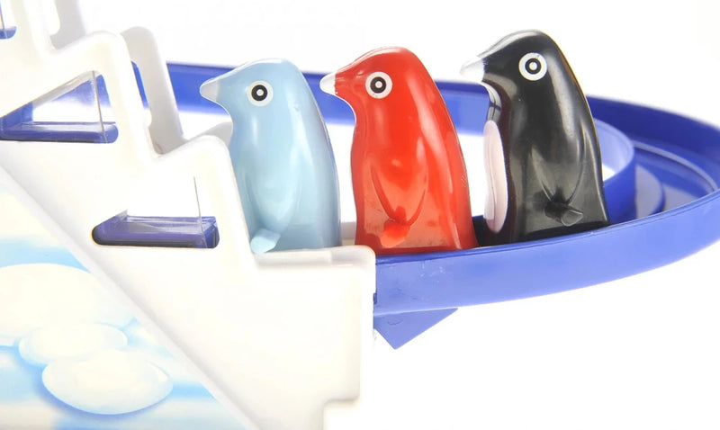 Three penguins lined up at the start of the Jolly Penguin Race toy track