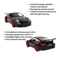 Black toy car with red accents on a white background, featuring text about its features.