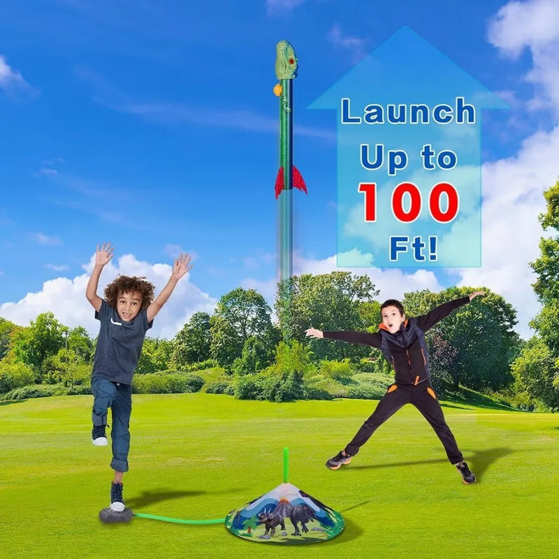 Two kids launching dinosaur rocket toys high into the sky, enjoying a fun outdoor activity.

