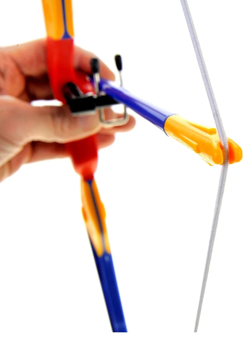 "Child holding and loading the toy bow and arrow, ready for safe and fun target practice