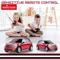 Two children playing with the Mini Cooper remote control car by Rastar, showcasing sensitive control.