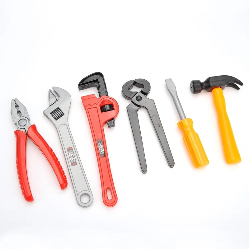 Selection of kids' toy tools including hammer, wrench, screwdriver, and pliers from a tool box playset