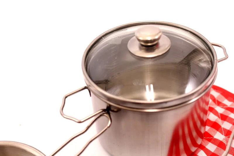 Stainless steel kitchen play set boxed and ready for kids, featuring multiple pots, pans, and cooking utensils