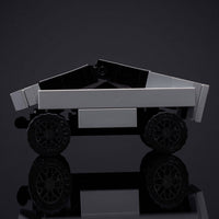 Toy truck made of interlocking bricks on a reflective surface with a dark background