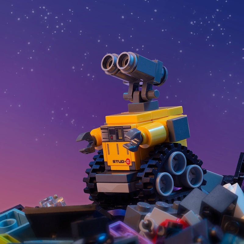Toy robot with binoculars against a starry sky background